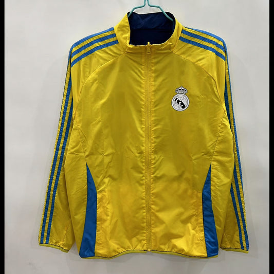 VESTE REAL MADRID COUPE-VENT 25/26 RÉVERSIBLE JAUNE ET BLEU MARINE